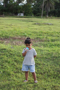 Full length of boy standing on field