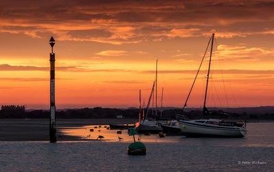 Sailboat in sea at sunset