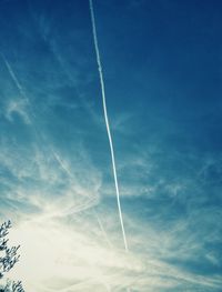 Low angle view of vapor trails in sky