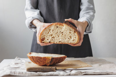 Midsection of person holding bread