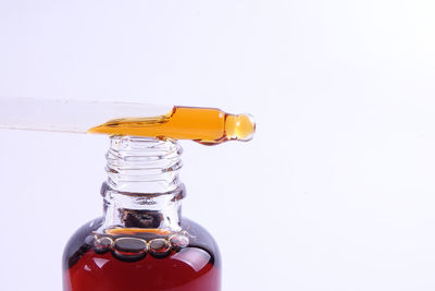 Close-up of glass bottle against white background