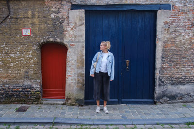 Full length of man standing against door