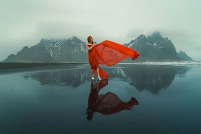 Sensual woman in red clothes on reynisfjara beach scenic photography