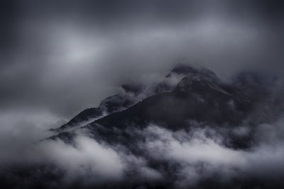 Low angle view of mountain against cloudy sky