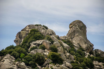 Low angle view of rock formation against sky