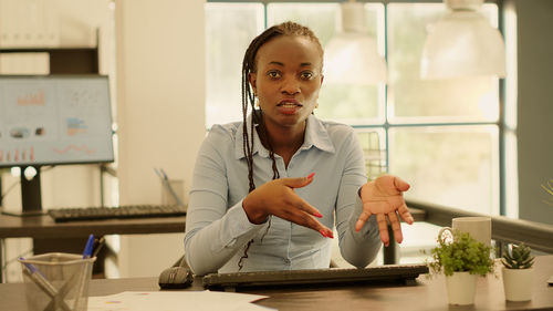 Portrait of young businesswoman working at table