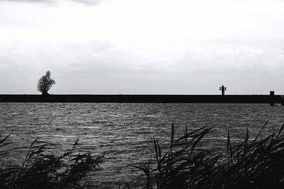 Scenic view of sea against cloudy sky