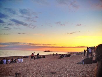 People on beach at sunset