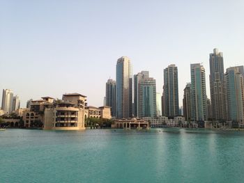 Buildings in city against clear sky