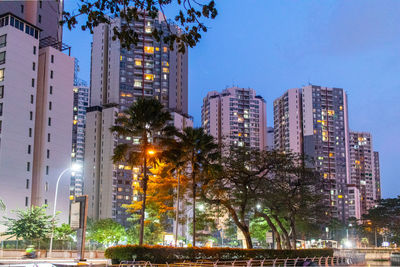 Illuminated buildings against sky at night