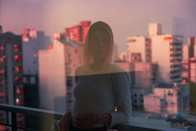 Woman leaning on railing in balcony