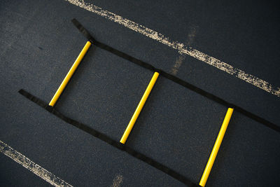 High angle view of yellow ladder against wall