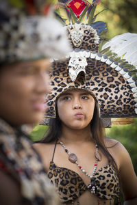 Portrait of young woman looking away outdoors