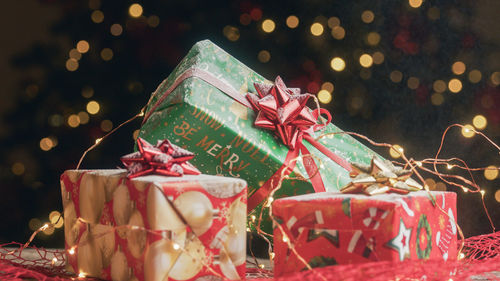 Christmas gift box on the table against the tree