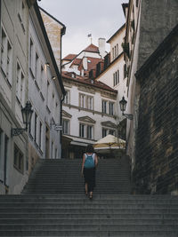 Woman walking through the city of prague, czech republic.