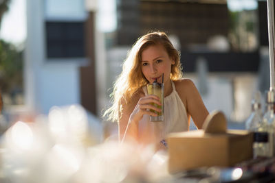 Young woman having drink at restaurant