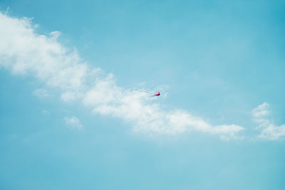 Low angle view of airplane flying in sky
