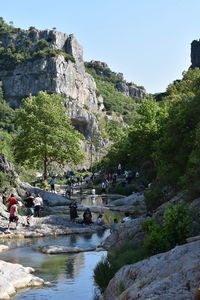 People on rocks by trees