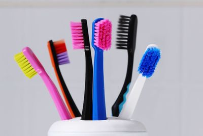 Close-up of multi colored toothbrushes in bathroom