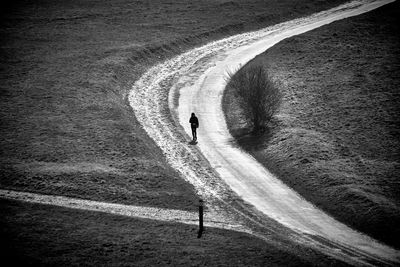 High angle view of woman walking on road