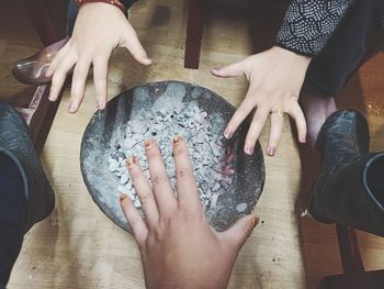 High angle view of hands on table