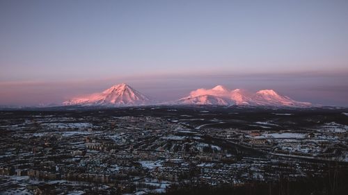 Scenic view of snowcapped mountains against sky during sunset