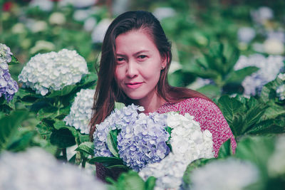 Portrait of woman with pink flower