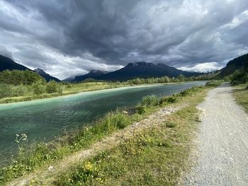 Scenic view of land and mountains against sky