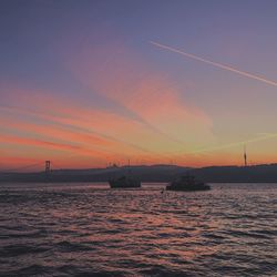 Scenic view of sea against orange sky