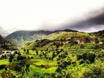 Scenic view of green landscape against sky