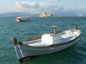 Boat sailing in sea against sky