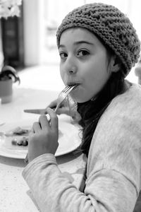 Portrait of girl eating food in restaurant