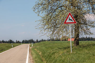 Road sign against sky