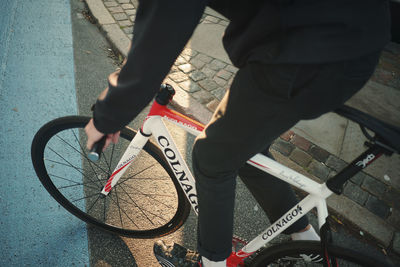 Low section of man riding bicycle on street