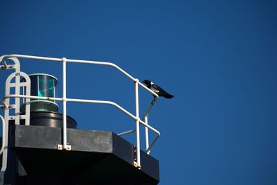 Low angle view of light against blue sky