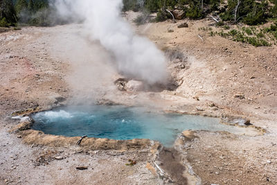 Smoke emitting from volcanic landscape