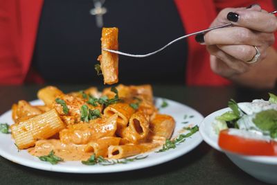 Close-up of hand holding food on table