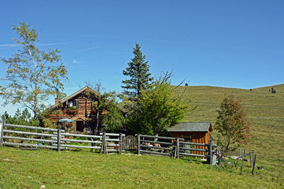 Built structure on field against clear blue sky