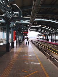 Man standing on railroad station platform