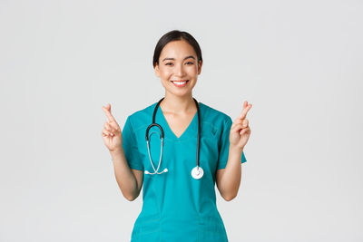 Portrait of a smiling young woman against white background