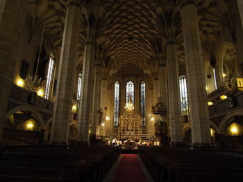 Illuminated cathedral amidst buildings at temple