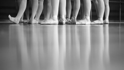 Low section of ballet dancers on floor