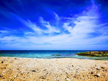 Scenic view of beach against blue sky