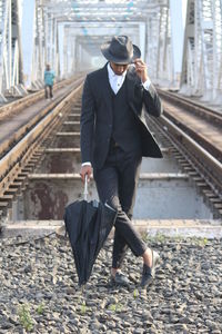 Full length of man walking on railroad station