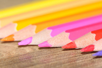 Close-up of multi colored pencils on table