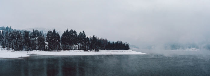 Scenic view of lake against sky during winter