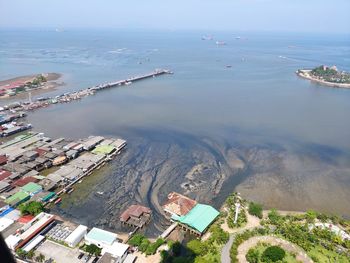 High angle view of sea and buildings in city