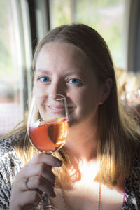 Portrait of smiling woman holding wineglass