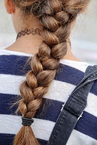 Rear view of young woman with braid