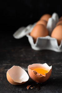 Close-up of broken egg on table